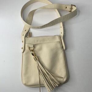 Kelly Tooke cream leather tasseled charm keychain crossbody bag